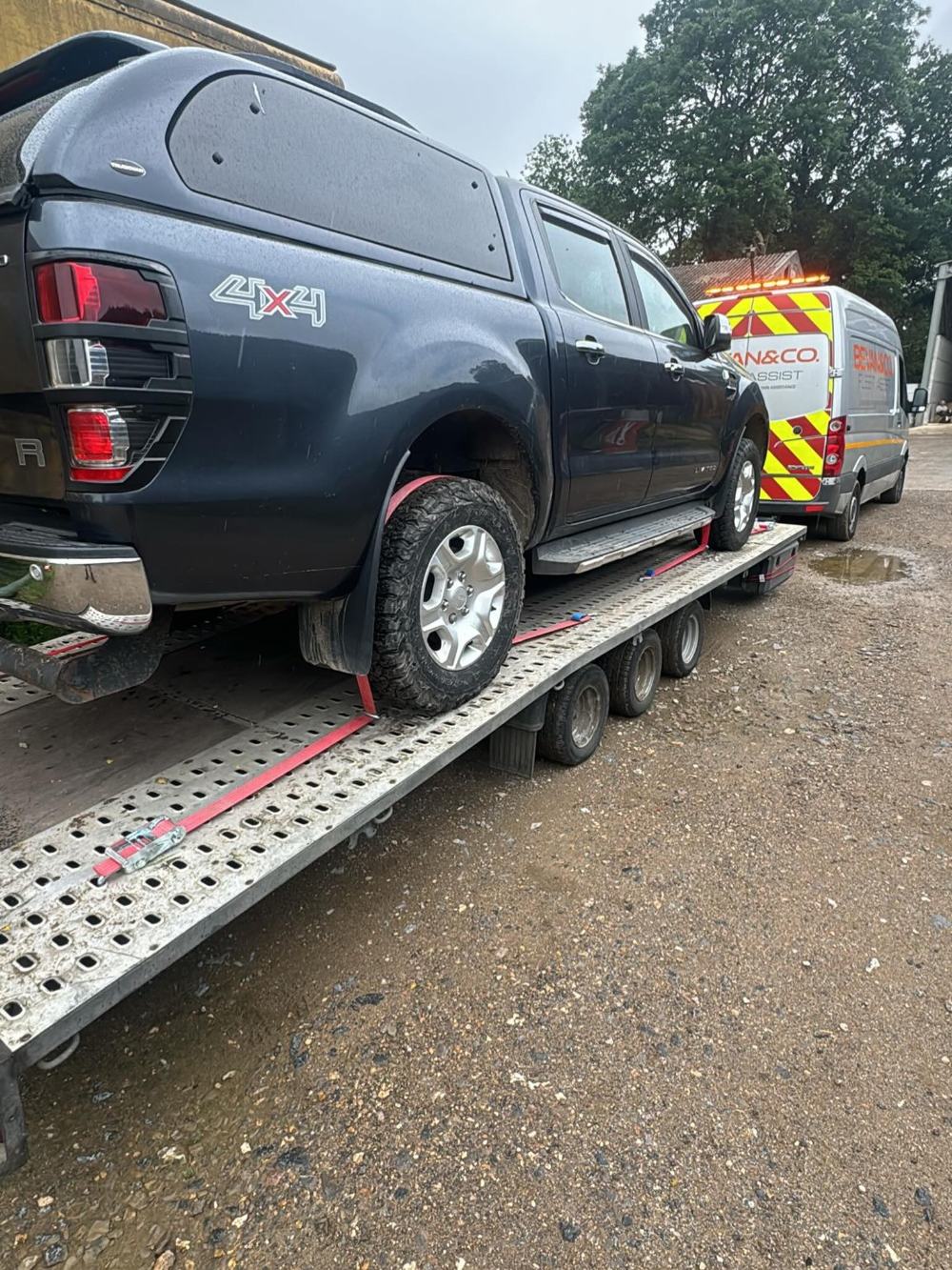 A pickup loaded on a recovery trailer